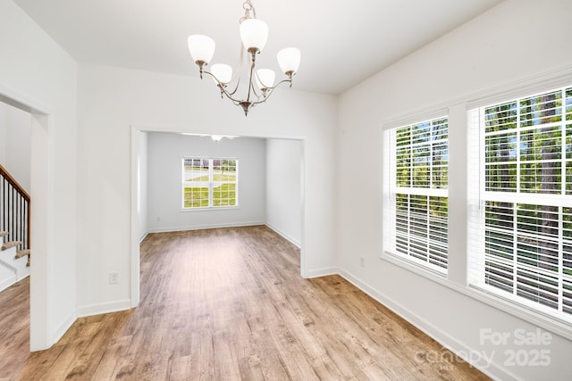 2612 Cold Springs Rd, Concord, NC 28025 - unfurnished room featuring a chandelier, light wood-style floors, and stairway