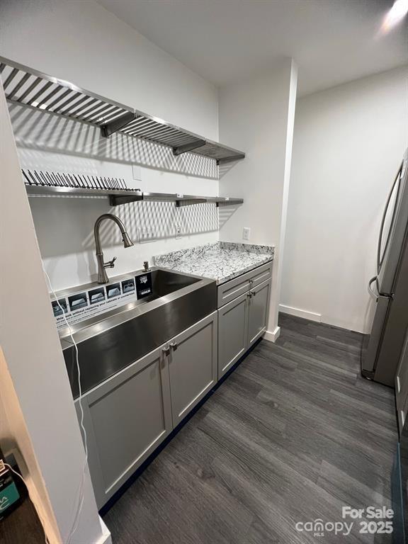 338 Orchard Trace Ln Unit 8, Charlotte, NC 28213 - kitchen featuring open shelves, dark wood finished floors, gray cabinets, freestanding refrigerator, and light stone counters