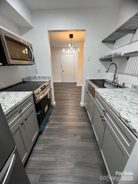 338 Orchard Trace Ln Unit 8, Charlotte, NC 28213 - kitchen with stainless steel microwave, open shelves, a ceiling fan, electric stove, and dark wood-style floors