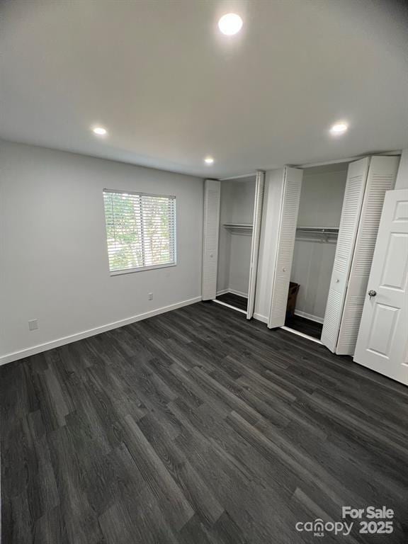 338 Orchard Trace Ln Unit 8, Charlotte, NC 28213 - unfurnished bedroom featuring multiple closets, dark wood-style floors, recessed lighting, and baseboards