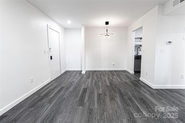 338 Orchard Trace Ln Unit 8, Charlotte, NC 28213 - unfurnished dining area with dark wood-type flooring, baseboards, and a chandelier