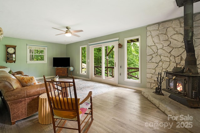 24 Cataloochee Ln, Waynesville, NC 28785 - living area with a wood stove, a ceiling fan, and wood finished floors