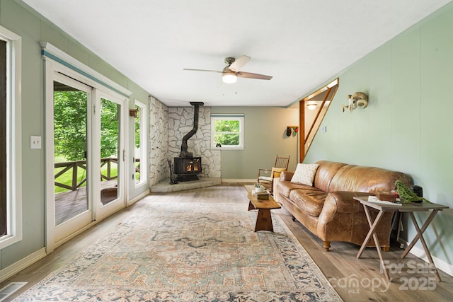 24 Cataloochee Ln, Waynesville, NC 28785 - living area featuring a wood stove, wood finished floors, and ceiling fan