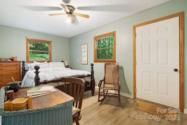 24 Cataloochee Ln, Waynesville, NC 28785 - bedroom featuring light wood finished floors and ceiling fan