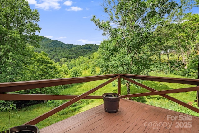 24 Cataloochee Ln, Waynesville, NC 28785 - wooden deck with a wooded view and a lawn