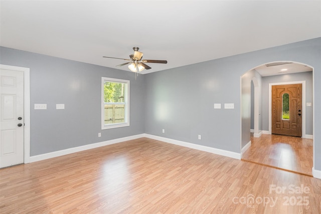 952 Salisbury St, Wadesboro, NC 28170 - foyer entrance with arched walkways, a ceiling fan, and light wood finished floors