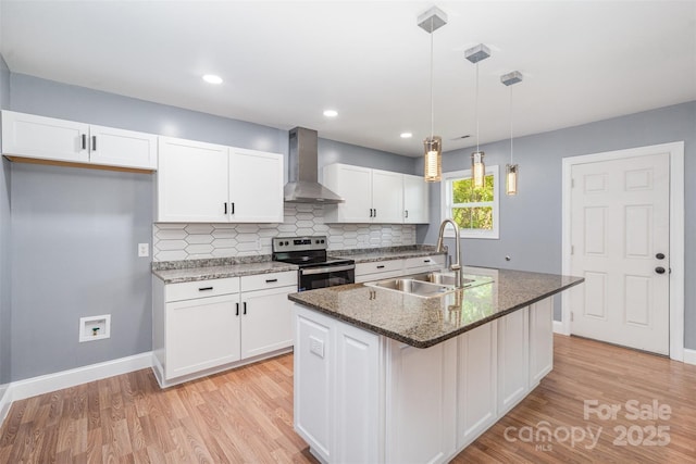 952 Salisbury St, Wadesboro, NC 28170 - kitchen with wall chimney exhaust hood, stainless steel electric stove, white cabinetry, light wood finished floors, and recessed lighting