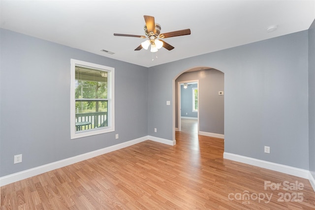 952 Salisbury St, Wadesboro, NC 28170 - empty room featuring a ceiling fan, arched walkways, light wood-style floors, and a smoke detector