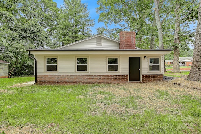 240 Swink Ave, Salisbury, NC 28147 - rear view of property featuring a chimney, a lawn, and brick siding