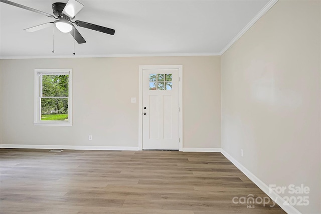 240 Swink Ave, Salisbury, NC 28147 - foyer entrance with healthy amount of natural light, ornamental molding, baseboards, a ceiling fan, and light wood-style floors