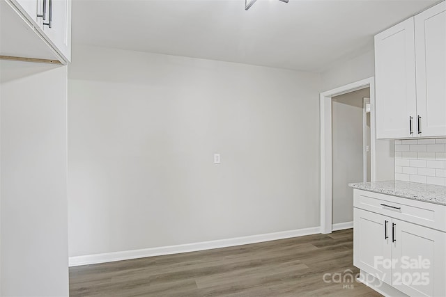 240 Swink Ave, Salisbury, NC 28147 - unfurnished dining area featuring wood finished floors and baseboards