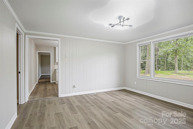 240 Swink Ave, Salisbury, NC 28147 - empty room featuring light wood-style floors, ornamental molding, baseboards, and a chandelier