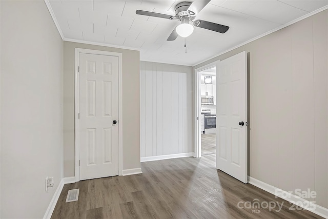 240 Swink Ave, Salisbury, NC 28147 - unfurnished bedroom with ornamental molding, wood finished floors, baseboards, and a ceiling fan