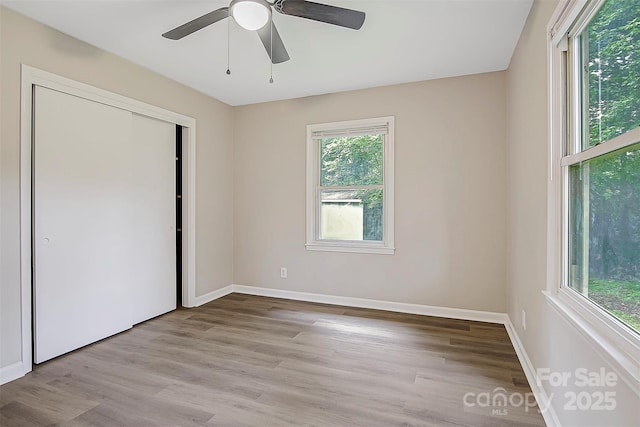 240 Swink Ave, Salisbury, NC 28147 - unfurnished bedroom with wood finished floors, baseboards, a closet, and ceiling fan