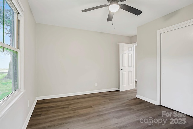 240 Swink Ave, Salisbury, NC 28147 - unfurnished bedroom featuring multiple windows, wood finished floors, and baseboards