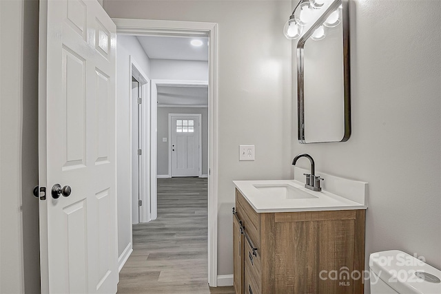 240 Swink Ave, Salisbury, NC 28147 - bathroom featuring vanity, wood finished floors, baseboards, and toilet