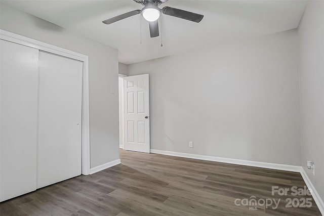 240 Swink Ave, Salisbury, NC 28147 - unfurnished bedroom with wood finished floors, baseboards, a closet, and ceiling fan