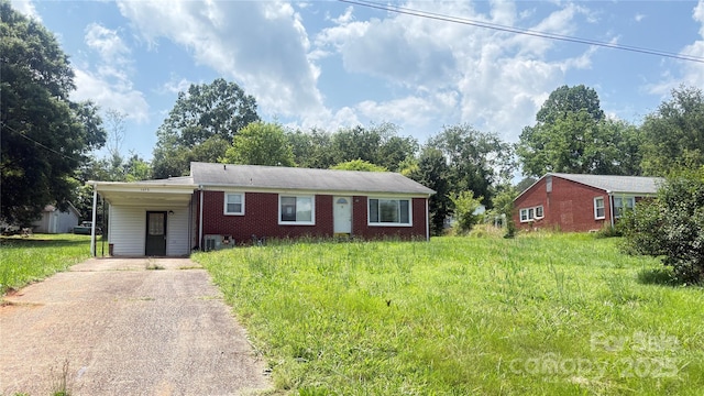1073 Springdale Dr, Maiden, NC 28650 - ranch-style house with driveway, central AC unit, an attached carport, and brick siding