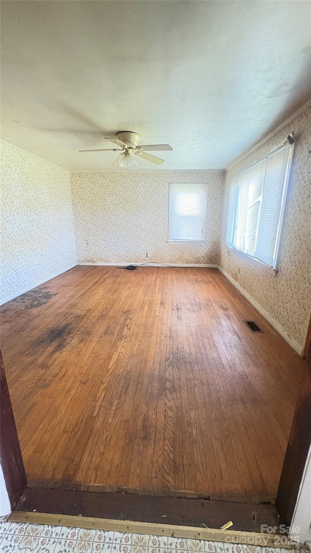 1073 Springdale Dr, Maiden, NC 28650 - empty room featuring wallpapered walls, hardwood / wood-style flooring, and a ceiling fan