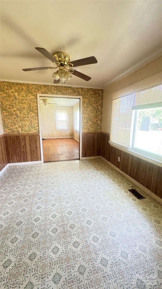 1073 Springdale Dr, Maiden, NC 28650 - empty room featuring ceiling fan, a wainscoted wall, and wood walls