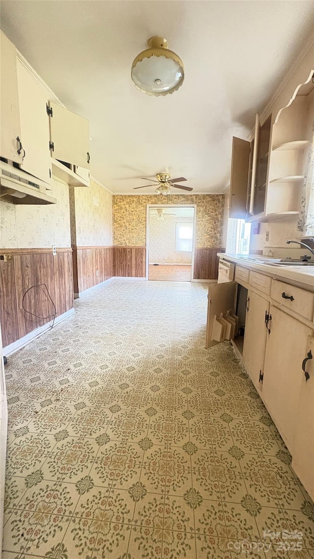 1073 Springdale Dr, Maiden, NC 28650 - kitchen featuring wallpapered walls, wainscoting, a ceiling fan, open shelves, and light countertops