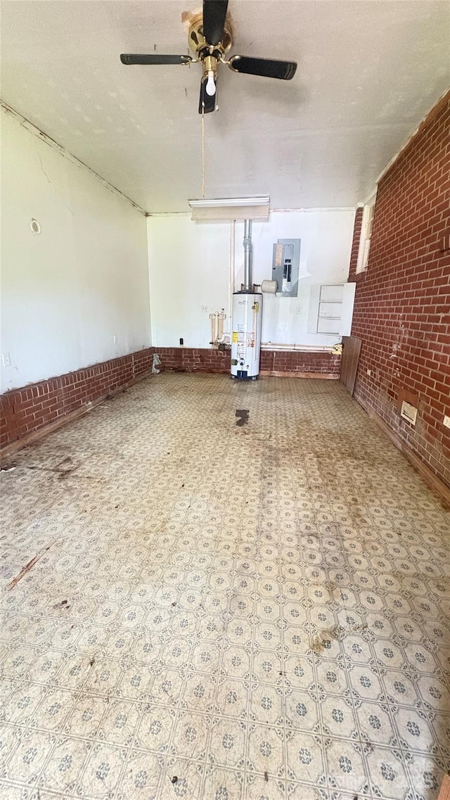 1073 Springdale Dr, Maiden, NC 28650 - unfurnished living room with brick wall, water heater, electric panel, tile patterned floors, and a ceiling fan