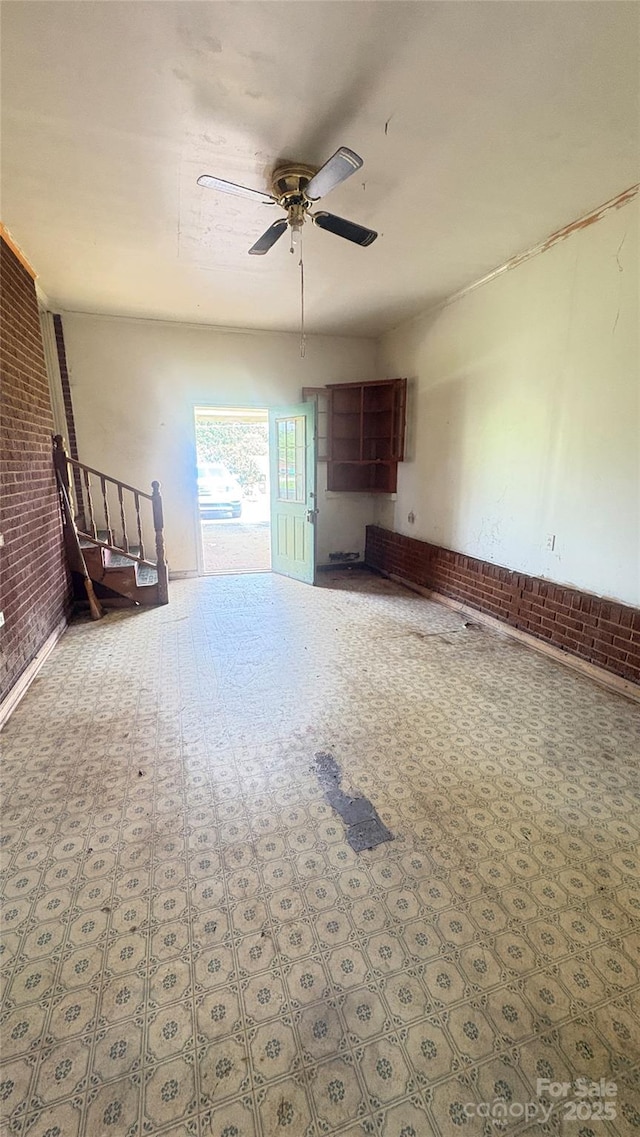 1073 Springdale Dr, Maiden, NC 28650 - unfurnished living room with brick wall and ceiling fan