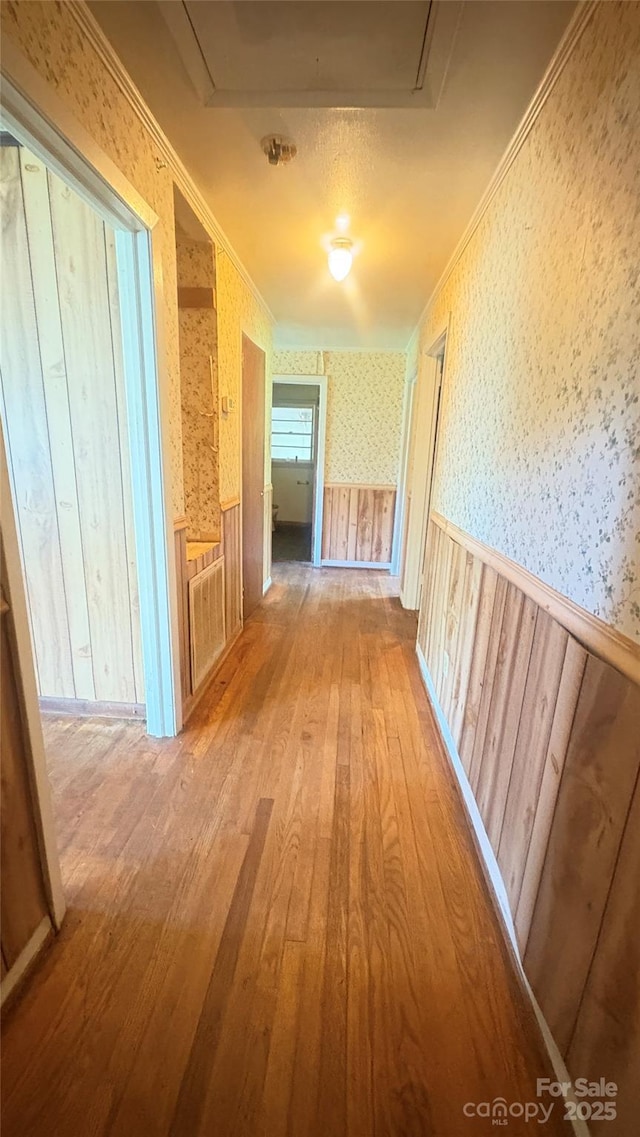 1073 Springdale Dr, Maiden, NC 28650 - hall featuring wood-type flooring, wallpapered walls, a wainscoted wall, ornamental molding, and attic access