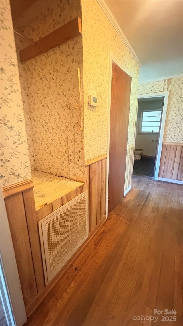 1073 Springdale Dr, Maiden, NC 28650 - corridor featuring wallpapered walls, wood finished floors, wainscoting, ornamental molding, and wood walls