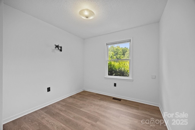 520 Forest St, Mars Hill, NC 28754 - unfurnished room with a textured ceiling, wood finished floors, and baseboards