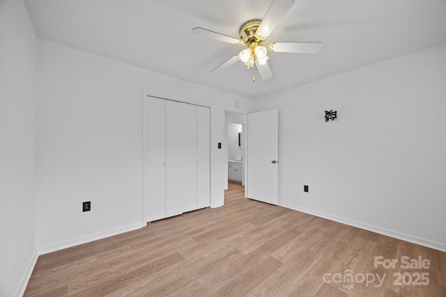 520 Forest St, Mars Hill, NC 28754 - unfurnished bedroom with light wood finished floors, baseboards, a closet, and ceiling fan