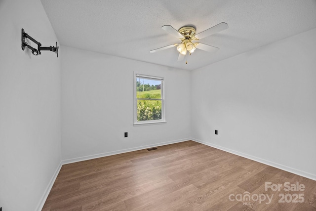 520 Forest St, Mars Hill, NC 28754 - unfurnished room featuring wood finished floors, ceiling fan, a textured ceiling, and baseboards