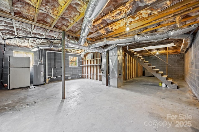 520 Forest St, Mars Hill, NC 28754 - below grade area with water heater, freestanding refrigerator, heating unit, concrete block wall, and stairway