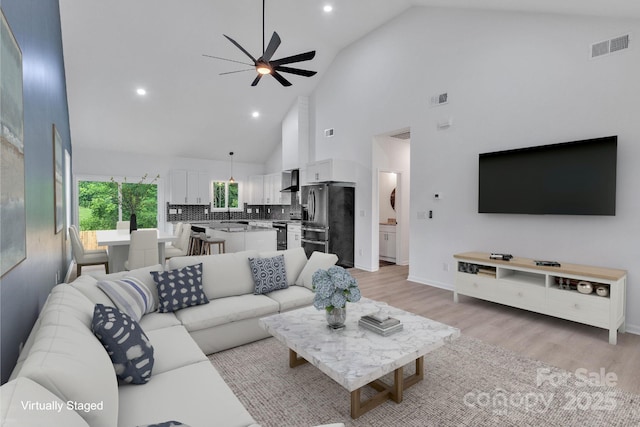 516 N Mulberry St, Cherryville, NC 28021 - living area featuring ceiling fan, high vaulted ceiling, light wood finished floors, and recessed lighting