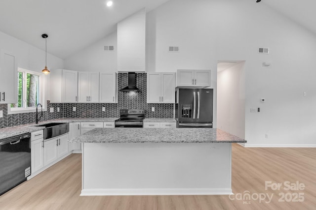 516 N Mulberry St, Cherryville, NC 28021 - kitchen featuring stainless steel appliances, wall chimney exhaust hood, high vaulted ceiling, light wood-type flooring, and a kitchen island