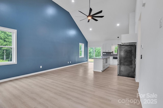 516 N Mulberry St, Cherryville, NC 28021 - unfurnished living room with high vaulted ceiling, a ceiling fan, light wood-style flooring, and recessed lighting