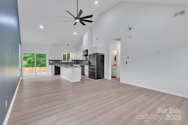516 N Mulberry St, Cherryville, NC 28021 - unfurnished living room with high vaulted ceiling, ceiling fan, light wood-style floors, and recessed lighting