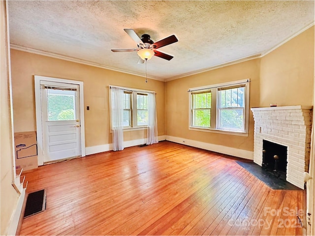 602 Brookshire St, Asheville, NC 28803 - unfurnished living room featuring light wood-style floors, plenty of natural light, ornamental molding, a textured ceiling, and ceiling fan