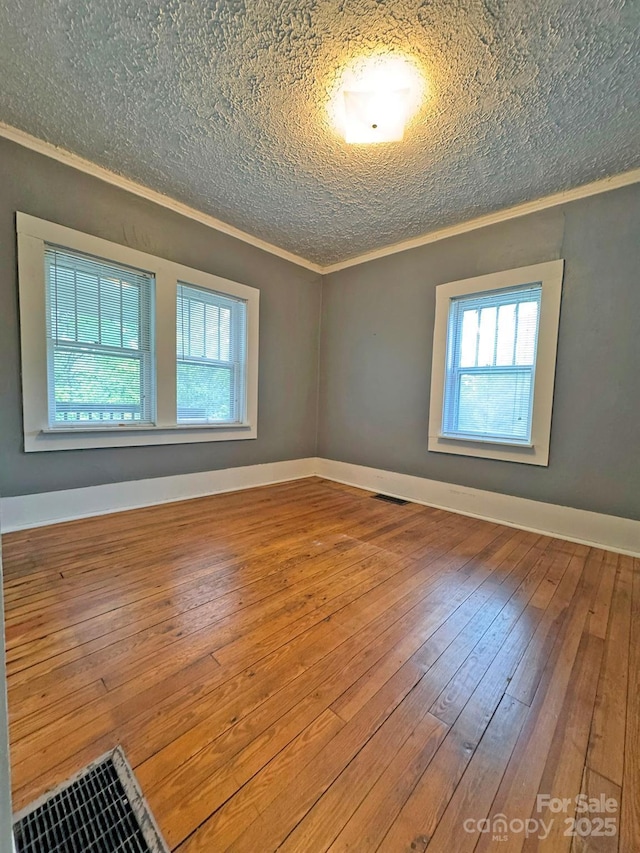 602 Brookshire St, Asheville, NC 28803 - spare room with ornamental molding, healthy amount of natural light, hardwood / wood-style floors, a textured ceiling, and baseboards