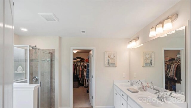 2009 Trindle Vine Ln, Waxhaw, NC 28173 - full bath with double vanity, a spacious closet, a shower stall, and baseboards
