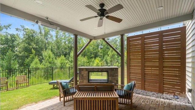 2009 Trindle Vine Ln, Waxhaw, NC 28173 - sunroom / solarium featuring ceiling fan, outdoor lounge area, and view of wooded area