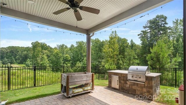 2009 Trindle Vine Ln, Waxhaw, NC 28173 - fenced backyard with ceiling fan and a patio area