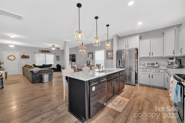 210 Clove Hitch Dr, Statesville, NC 28677 - kitchen with black appliances, a sink, healthy amount of natural light, and a breakfast bar area