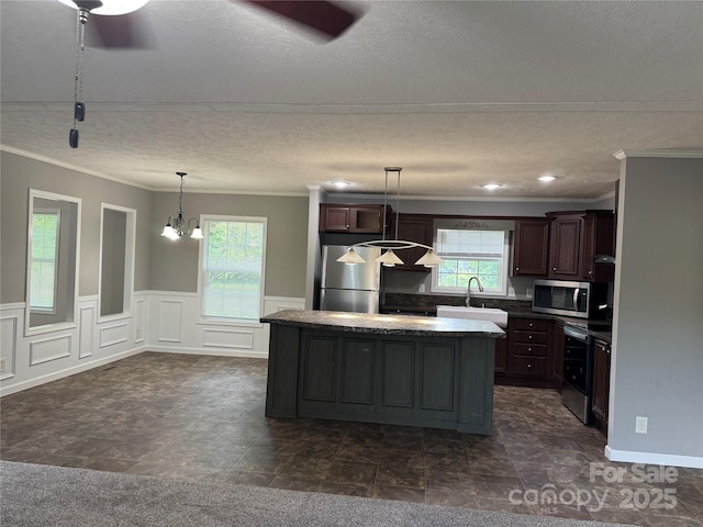 1555 Moore Rd, York, SC 29745 - kitchen featuring appliances with stainless steel finishes, a sink, plenty of natural light, crown molding, and a kitchen island