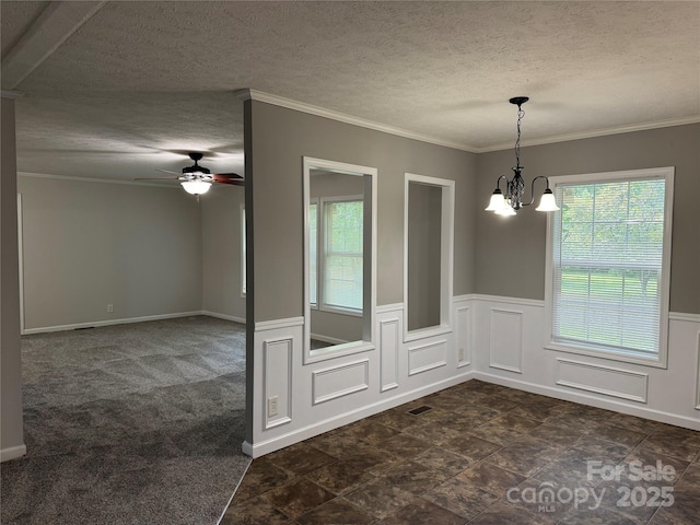1555 Moore Rd, York, SC 29745 - unfurnished dining area with a chandelier, a ceiling fan, a textured ceiling, ornamental molding, and a wainscoted wall
