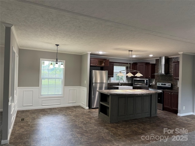 1555 Moore Rd, York, SC 29745 - kitchen featuring stainless steel appliances, wall chimney exhaust hood, plenty of natural light, crown molding, and a chandelier