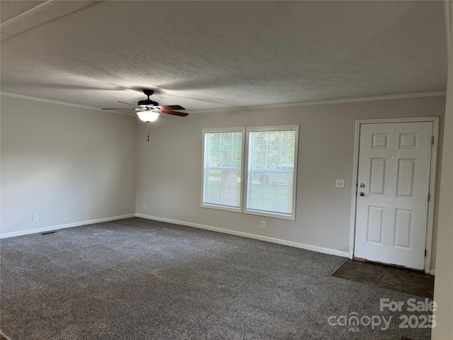 1555 Moore Rd, York, SC 29745 - spare room featuring dark carpet, ceiling fan, baseboards, crown molding, and a textured ceiling