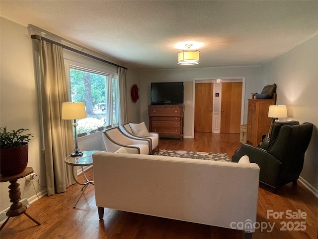 103 Boyd Dr, Stanley, NC 28164 - living room featuring wood finished floors, baseboards, and a textured ceiling