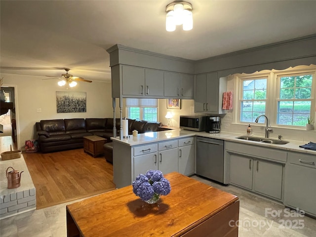 103 Boyd Dr, Stanley, NC 28164 - kitchen with appliances with stainless steel finishes, a sink, healthy amount of natural light, light countertops, and ornamental molding