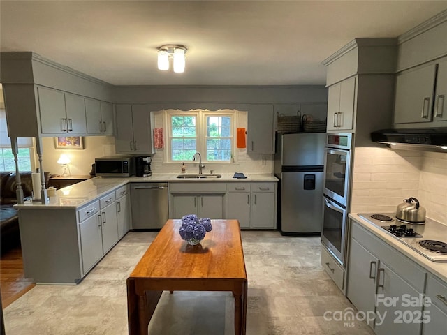 103 Boyd Dr, Stanley, NC 28164 - kitchen with stainless steel appliances, ventilation hood, a sink, backsplash, and light countertops